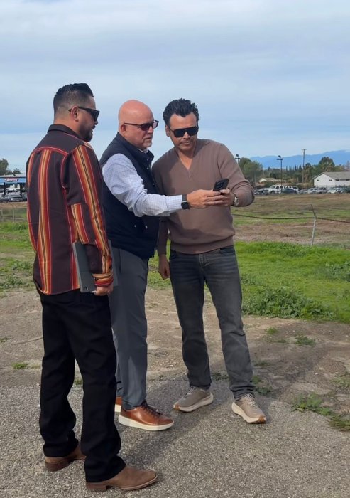 Andrew meeting with others at a development site